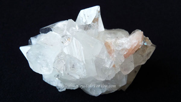 Clear Apophyllite Cluster with Peach Stilbite Inclusion Clear Apophyllite Cluster with Peach Stilbite Inclusion